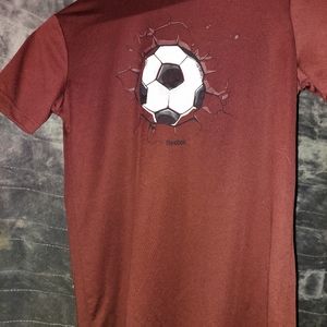 A soccer Reebok shirk it is redish brown. It is a size 14-16. For boys.